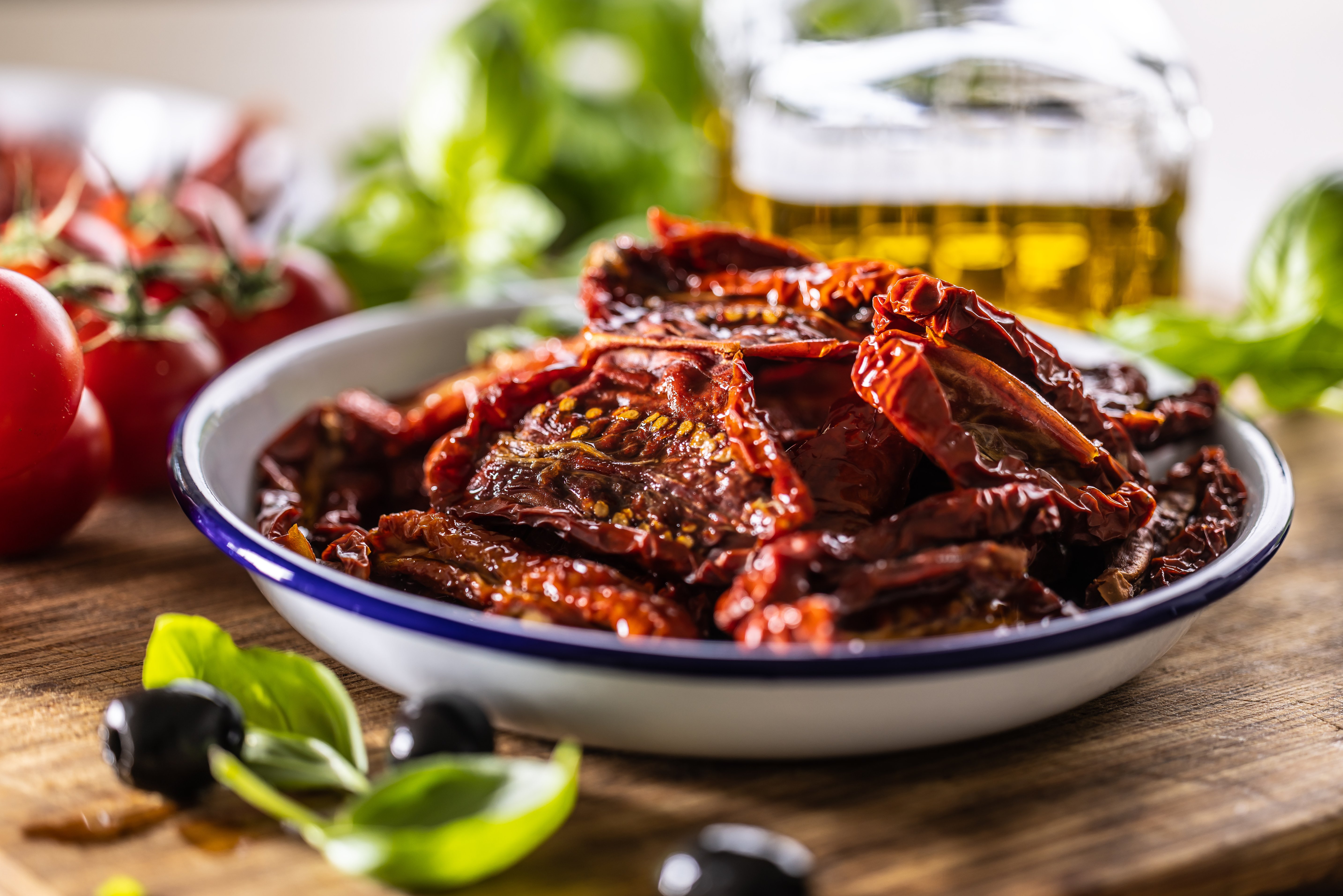 Sun-dried tomatoes marinated in olive oil with herbs and olives.