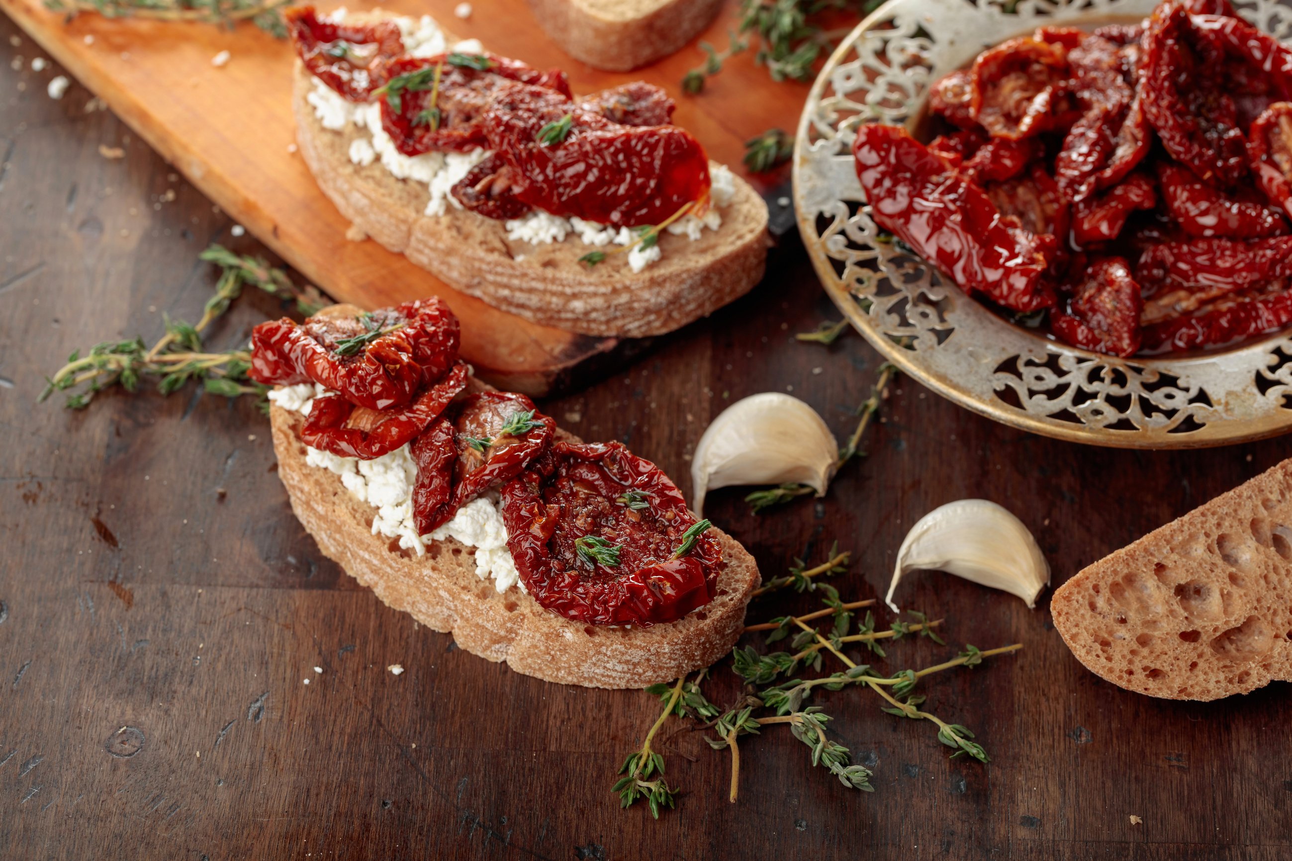 Bruschetta with ricotta, sun-dried tomatoes, and thyme.